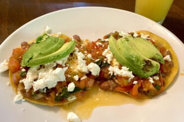 Huevos rancheros today. Fresh tomatoe salsa, queso fresco, over medium eggs, Avocado, and frijoles de la olla.