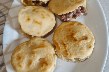 Homemade corn 'gorditas' filled with sliced potatoes with chile, beans and cheese
