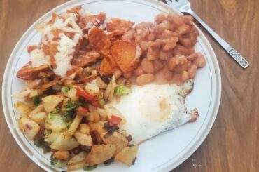 My Mom made some cheesy chilaquiles, beans, an over-easy egg, and some papas