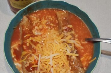 Rolled up ground beef tacos dipped in tomato sauce and cheese (chicos tacos style)