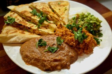 Chicken Quesadilla, refried beans, Mexican rice, and guacamole