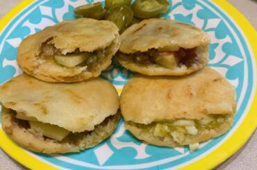 Corn gorditas filled with sliced potatoes w/ green sauce, beans and cheese