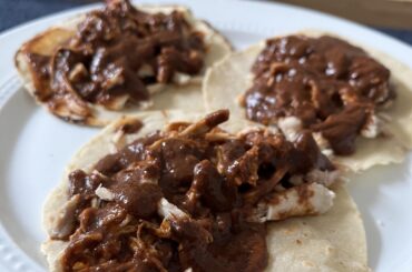 Homemade mole rojo in chicken taco form