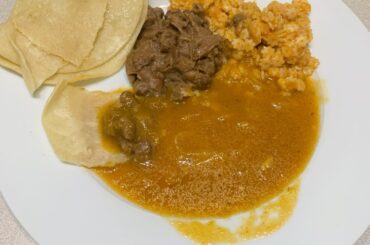 Chile sauce w/ sliced onions, estrellitas pasta and refried beans