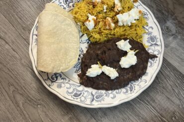 Arroz y frijoles and homemade corn tortillas, with goat cheese and secret ardvark hot sauce on top
