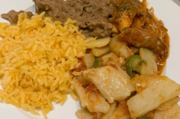 Sardine w/ tomato sauce, sliced potatoes, rice & beans