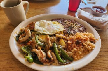 Pocho breakfast - chicken fajitas, rice, beans, eggs, tortilla, and a warm cafe de olla.