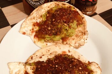 Tortilla, gooey fried egg, guacamole, hot sauce, chile flakes. Simple but delicious.