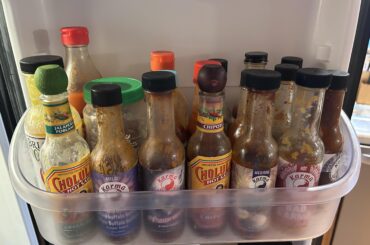 My daughter and son-in-law’s fridge shelf just for hot sauce!