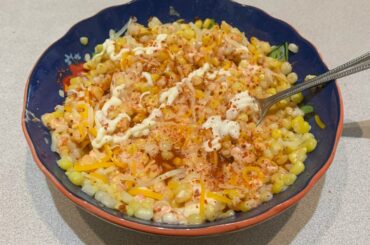 Homemade street corn cup (elote en vaso). Ingredients: corn, mayo, butter, tajin, lime, salt, botanera sauce & cheese.