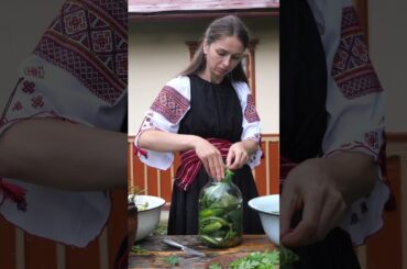 Best snack! A woman in the village is making pickles for the winter (fermented cucumbers)