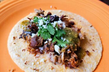A big taco de carnitas (with tomatillo lime salsa and cotija)