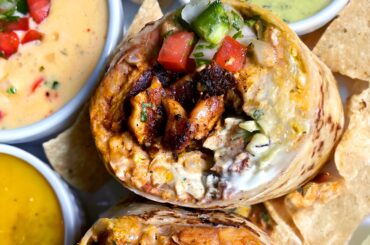 Homemade Mesquite Grilled Pollo Asado Burrito with Habanero Salsa, Salsa Verde, Chips and Queso