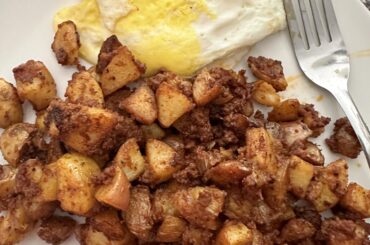 Papas con chorizo and overhard eggs