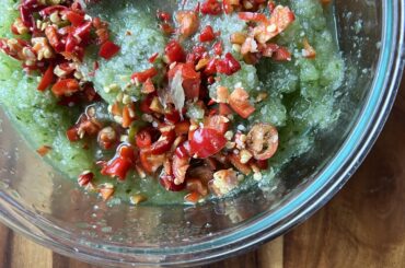 A "salsa" made from left over cucumber pulp from an agua fresca, ripe jalapenos, chile de arbol, lime juice and salt. Cucumbers and peppers from my garden. So far it's delicious - it'll be better after a couple hours in the fridge.