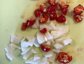 Marinating fresh garlic and fresh chili peppers in soy sauce