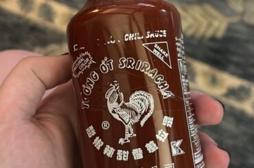 A full bottle of Sriracha that expired in May 2023