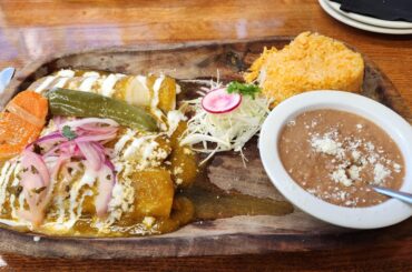 Local plates. Enchiladas carnitas and birria taco plate.