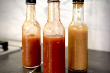 Three unique hot sauces: mango habanero, cherry bomb pepper and pineapple habanero with miso