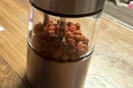 A powered grinder with Central Texas dried fave