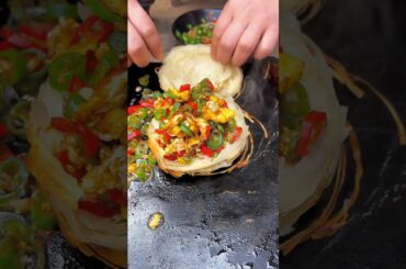 Chinese burger Stir-fried eggs with chili on a stone slab