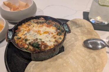 Chorizo fundido, braised short ribs with mole coloradito, and lobster sauce chilaquiles with grilled shrimp.