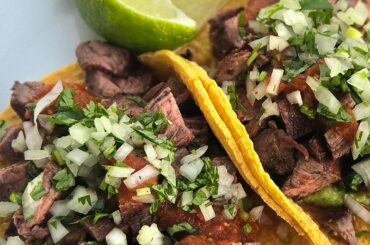 Skirt steak with guacamole and chile de arbol salsa on homemade corn tortillas