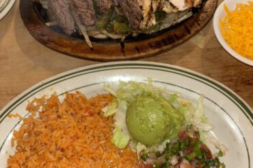 Fajita Platter Red Rice (Arroz Rojo), with a side of lettuce, pico de gallo, and a guacamole alongside with carne asada and a chicken what y'all think