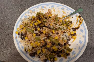 Healthy lunch, rice and beans and green beans and corn and tuna and cheese mixed with fly by Jing chili oil.