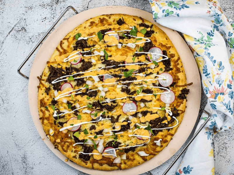 Birria Pizza on a pizza stone.