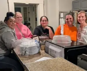 Take 2 Cafe program participants cook in a kitchen. (Provided by Hillary Parkhurst Sutton)