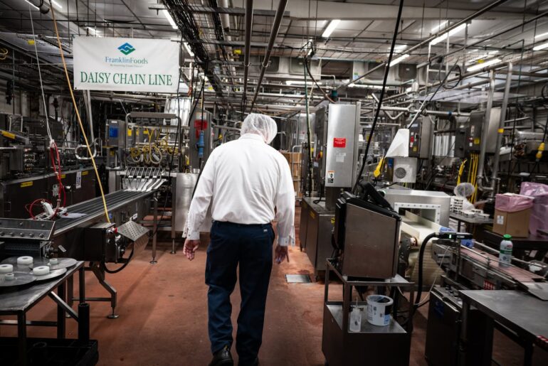 John Ovitt, plant manager of Franklin Foods, inspected a production line that packages specialty cream cheese for restaurants and brands in Enosburgh, Vt., in July. The plant is shutting down, but Ovitt is taking it over and reopening it as Franklin County Cheese.