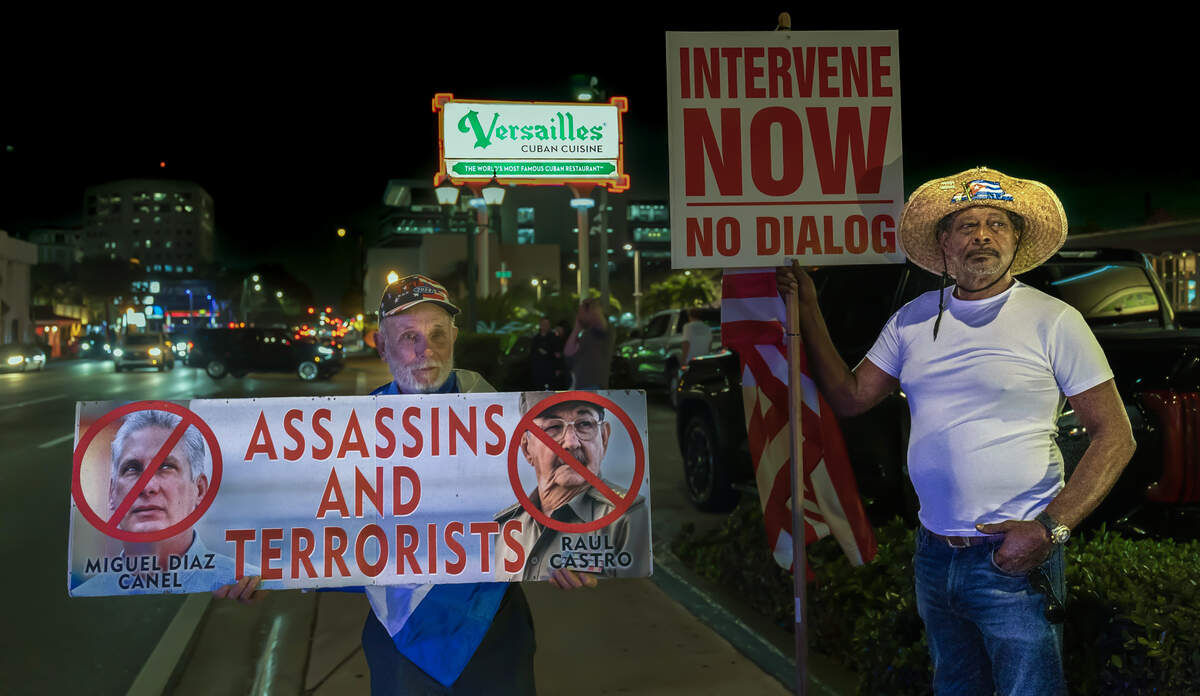 A group of Cuban exiles including Agustin Acosta (left) and Santiago Ferran, attended a vigil held at the iconic Versailles Cuban Cuisine Restaurant after four people were killed after a gunfire a day after a erupted between a Florida boat and the Cuban Coast Guard, at sea in Cuba, on Thursday, February 26, 2026.