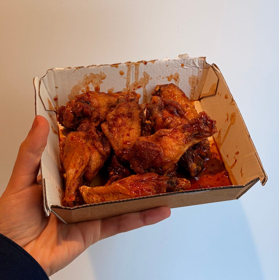 container holding cooked chicken wings container holding cooked chicken wings
