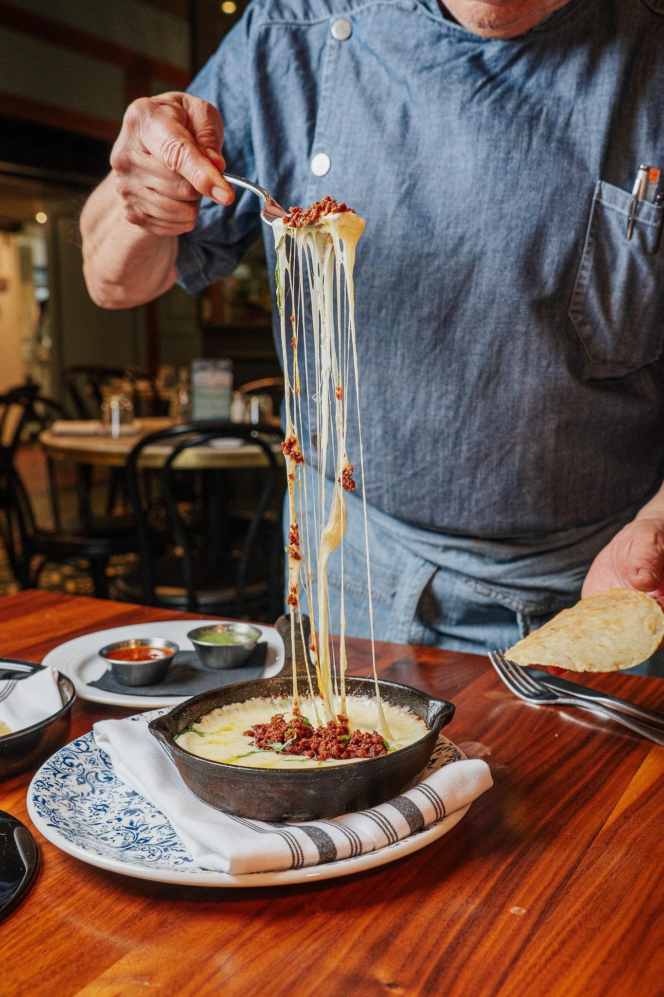 A cheese-pull on some queso fundido.