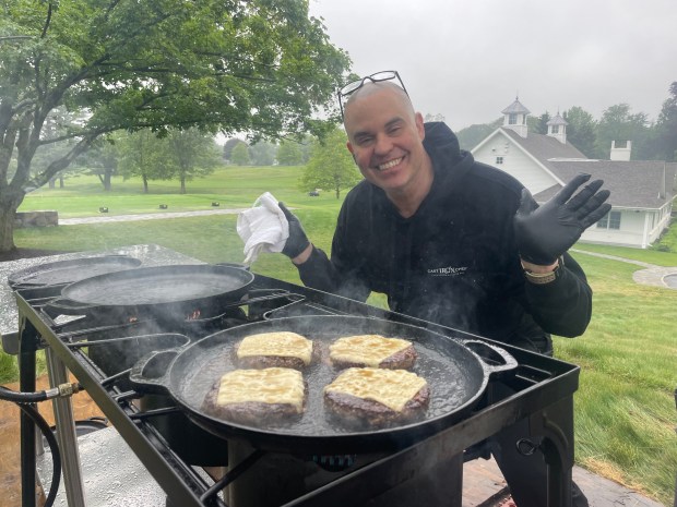 Cast Iron Chef catering role, Attilio Marini, owner of the popular Cast Iron Chef Chop House & Oyster Bar, 600 State St., New Haven, does the cooking from a black truck. (Courtesy)