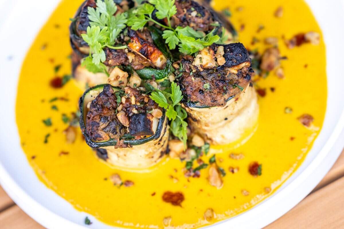 Stuffed summer squash featuring walnut, halloumi, herbs, saffron-tomato sauce during a soft opening in June 2023 at Ajja, a restaurant from Cheetie Kumar and Paul Siler in on Bickett Blvd. in Raleigh. Ajja focuses on Mediterranean, Middle Eastern and Southwest Asian flavors.