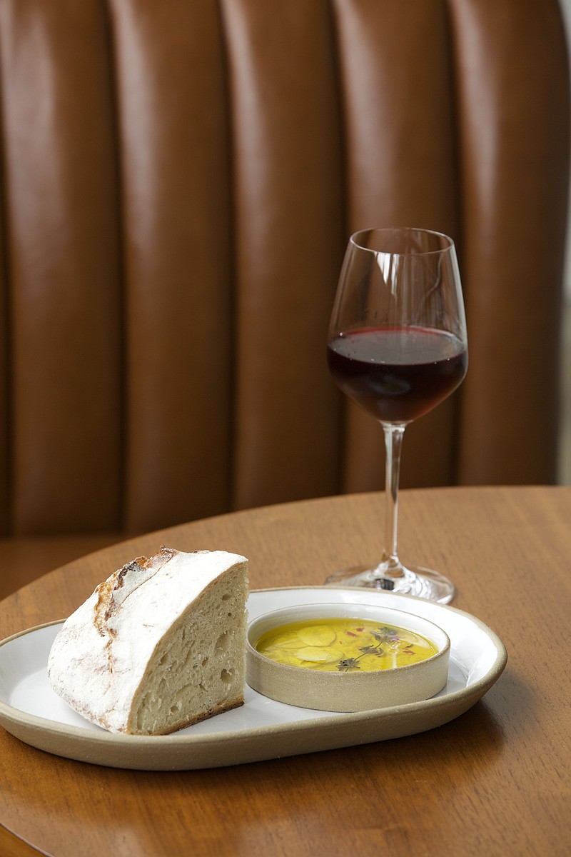 Photo by Lyric Lewin / Freshly made bread with infused olive oil and a glass of wine are seen at the restaurant Judith in Sewanee. Pictured here on June 26, 2026.