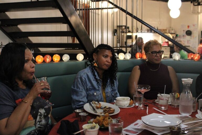 Three women sit around a table at Lula & Sadie's restaurant.