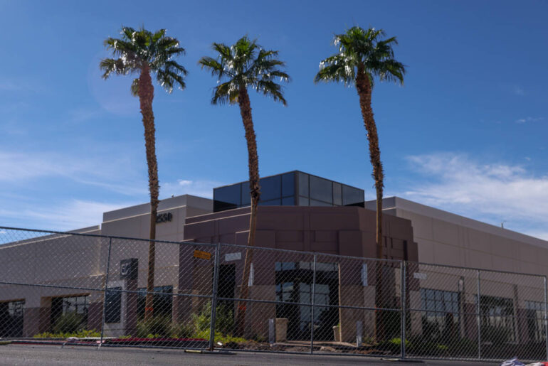 An office building is fenced off for retail redevelopment construction on Paseo Verde Parkway o ...