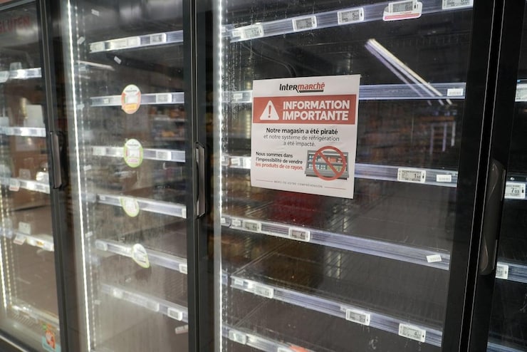 View of empty refrigerators at the frozen food aisle inside a supermarket.