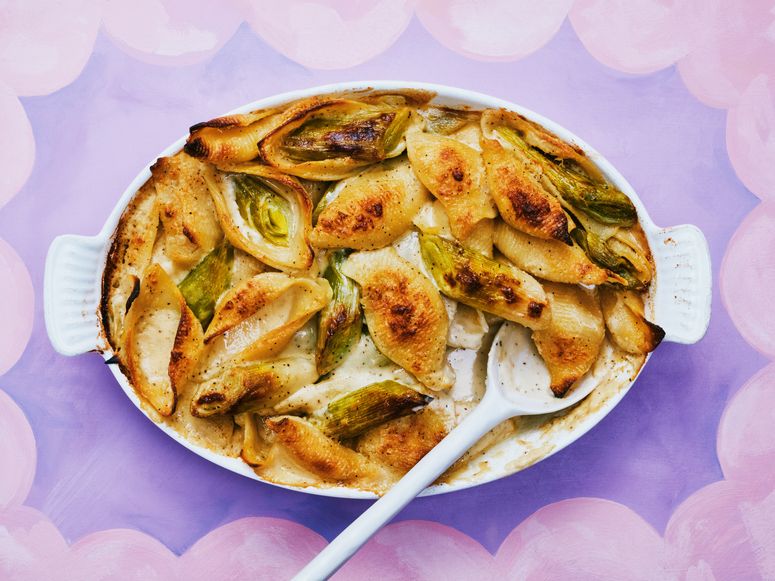 Leaks and Baked pasta in a white dish on purple baking dish